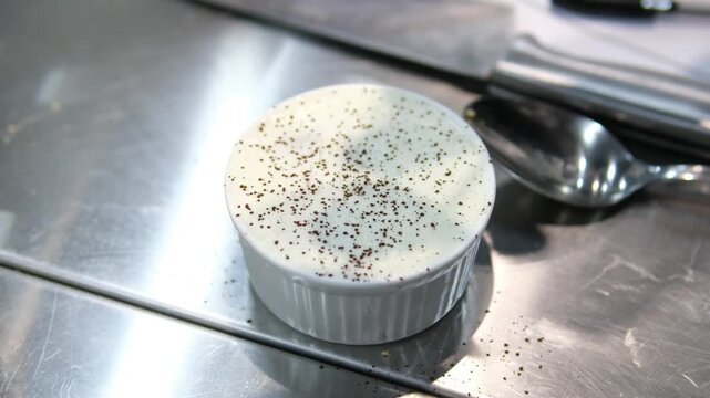 sprinkle cocoa on Tiramisu. Hand sprinkle cocoa powder on top of a tiramisu cake, homemade gluten-free Italian layered dessert with ladyfinger biscuit and mascarpone cream decorated with cocoa powder