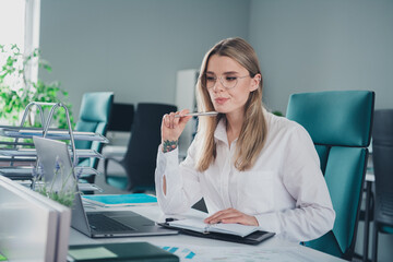 Photo of nice elegant young woman hold pen ponder laptop wear shirt modern office building indoors