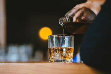 Whiskey drinks at the bar celebrating a special event in a luxury bar. Close-up shows a cheerful atmosphere as glasses clink together, reflecting a lively and joyful gathering.