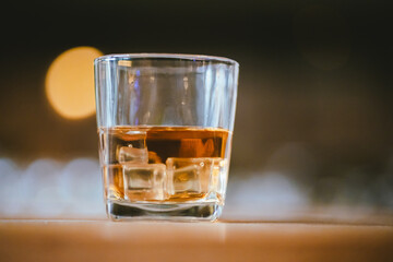 Whiskey drinks at the bar celebrating a special event in a luxury bar. Close-up shows a cheerful atmosphere as glasses clink together, reflecting a lively and joyful gathering.