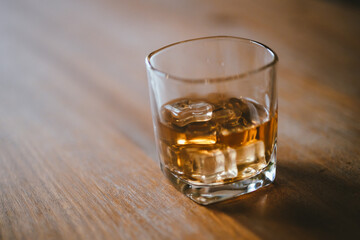 Whiskey drinks at the bar celebrating a special event in a luxury bar. Close-up shows a cheerful atmosphere as glasses clink together, reflecting a lively and joyful gathering.