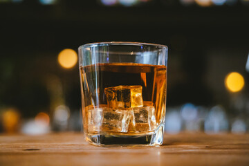 Whiskey drinks at the bar celebrating a special event in a luxury bar. Close-up shows a cheerful atmosphere as glasses clink together, reflecting a lively and joyful gathering.