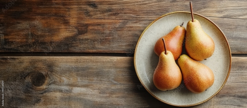 Fototapete plate with fresh pears on a wooden table. with copy space image. place for adding text or design
