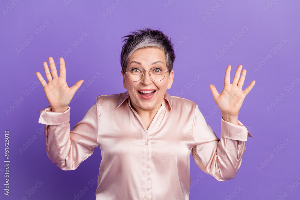 Wall mural Photo portrait of attractive retired woman raise hands excited dressed stylish satin clothes isolated on violet color background