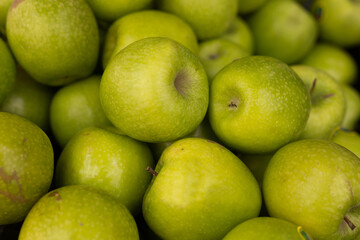 Delicious green apples on a market counter