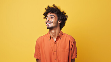Young Indian man smiling and looking away