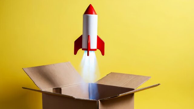 Toy rocket taking off from a cardboard box, startup and delivery concept.