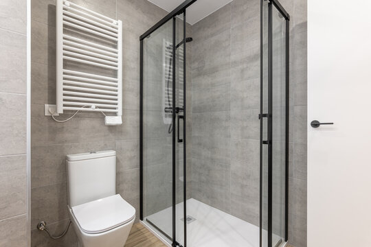 Modern bathroom with glass shower and slim toilet complements the stylish design of the apartment