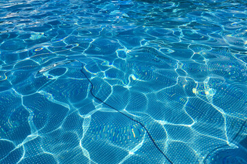 Transparent blue water in the pool. Water background.