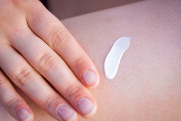 Girl applying cream. SPF cream. Cream texture. Close-up. Moisturizing cream. Beach time. Rest. Relaxation