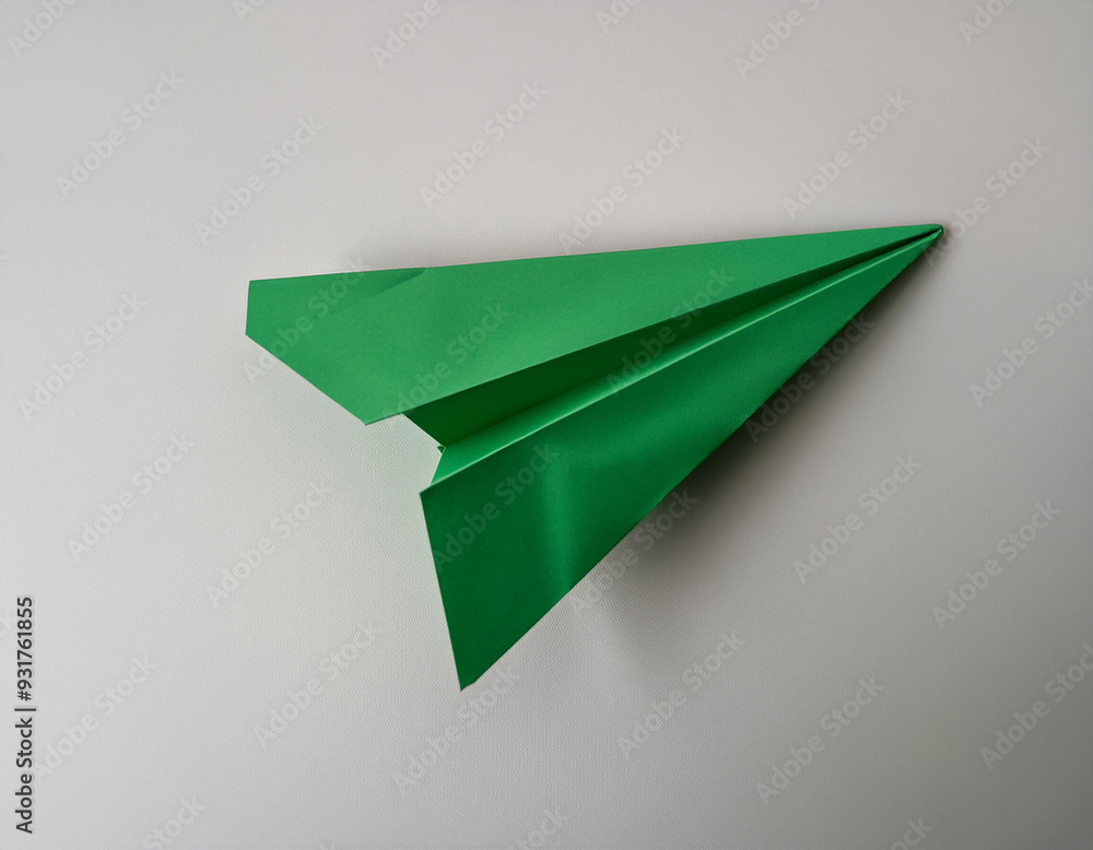 Poster a top view of a verdant paper aircraft on a light backdrop with an area for text.