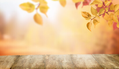 Wooden empty brown table and tree branches with autumn leaves. Autumn background