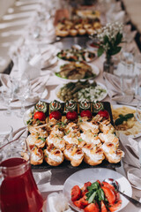anapes on wooden skewers on a buffet or banquet. Catering.	