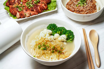 Fish maw vegetarian Taiwanese noodle soup With pork chop, minced pork rice, served in dish isolated on marble background side view of taiwan food