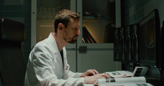 The radiologist examines the MRI images on the computer.
