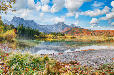 Fabulous autumn scene of sunny morning on Almsee lake.