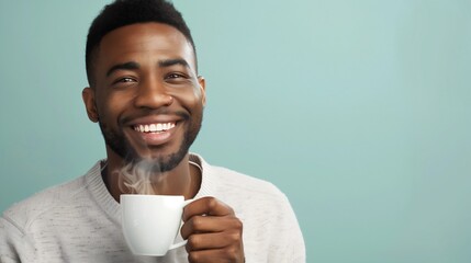 African American black man holding a hot cup of morning coffee, tea or warm beverage, smiling. Copy space Mock-up Isolated person Drink promotion advertising White shirt Fragrant aroma Studio photo 