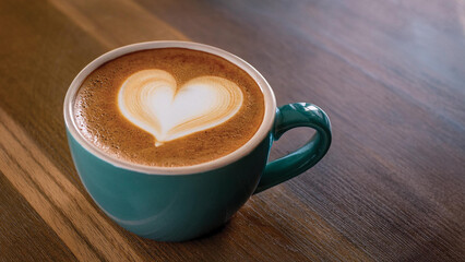 Coffee in a Teal Mug with a Heart Shape in the Foam