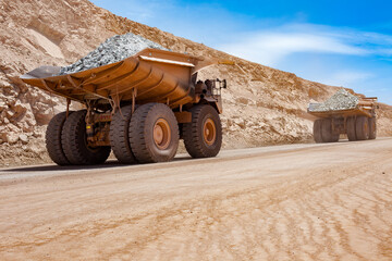 Obraz premium Huge large dump trucks at an open-pit copper mine in Peru.