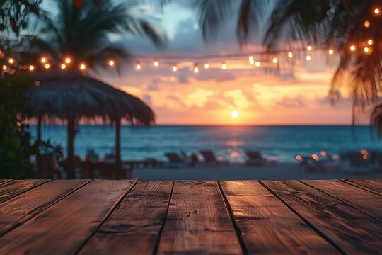 Empty wooden table with blurred beach bar at sunset