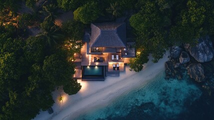 Fototapeta premium Aerial View of a Luxurious Beachfront Villa at Night