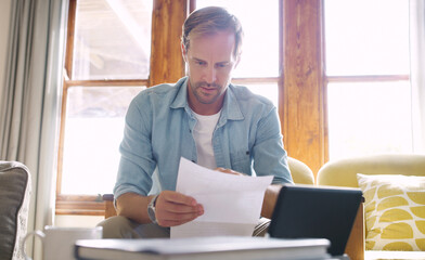 Serious, man and report with documents at house for tablet, financial bankruptcy and payment debt of mortgage. Person, reading and paperwork for budget crisis, eviction notice and risk management