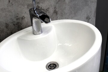 White ceramic sink with iron faucet.