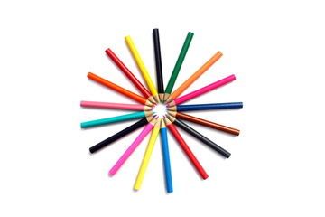 Colored pencils stacked in a circle on a white background