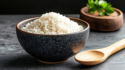 A Captivating Display of Organic Rice in a Beautiful Bowl with a Wooden Spoon by the Side