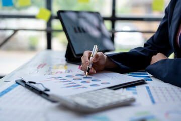 A person is writing on a piece of paper with a pen