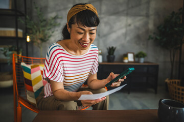 japanese woman have contactless payment, scan invoice on mobile phone