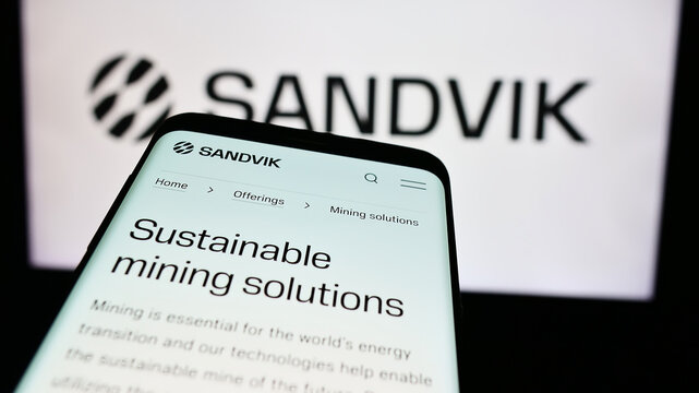 Stuttgart, Germany - 08-15-2024: Mobile phone with website of Swedish engineering company Sandvik AB in front of business logo. Focus on top-left of phone display.