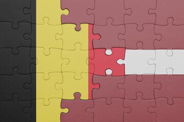 puzzle with the colourful national flag of latvia and flag of belgium.