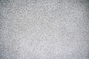 Textured White Plaster Wall Surface. Close-up view of a white plaster wall showcasing its fine texture and rough surface.