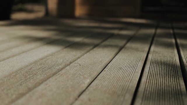 This is a beautifully textured wood deck that casts charming shadows on the patio surface