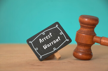 The gavel, a symbol of judicial authority, emphasizes the seriousness of an arrest warrant and the...