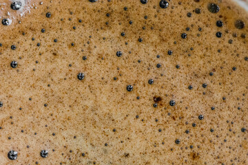 The surface of hot coffee in close-up