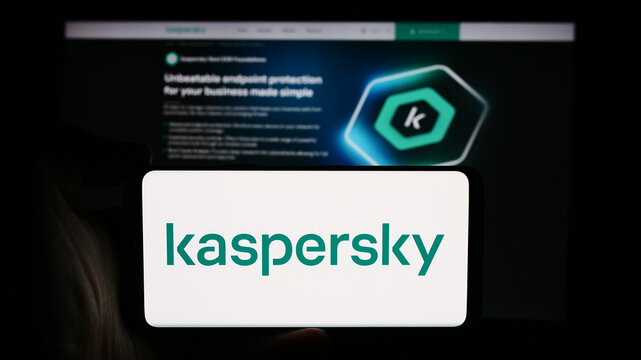 Stuttgart, Germany - 08-18-2024: Person holding cellphone with logo of Russian cybersecurity company AO Kaspersky Lab in front of business webpage. Focus on phone display.