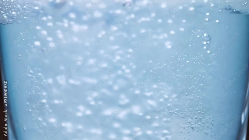 Poster refreshing image of tiny bubbles rising to the surface of a glass, creating a beautiful and abstract