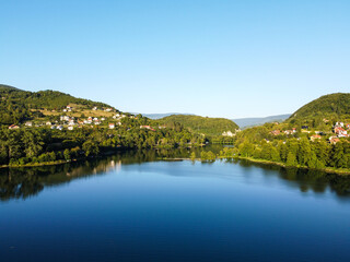 A lake located between mountains, aerial drone view. A natural lake between the hills. Plivsko lake, Jajce, Bosnia and Herzegovina. 