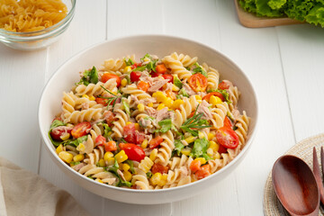 Homemade macaroni salad with trivelle pasta and canned tuna, carrot, Head Lettuce, tomato, corn and...