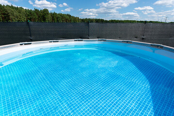 Large expansion pool with a diameter of 3.96 m, located in the yard on the grass.
