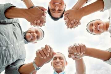 Below, family and holding hands in circle outdoor for support peace, love and bonding together on...