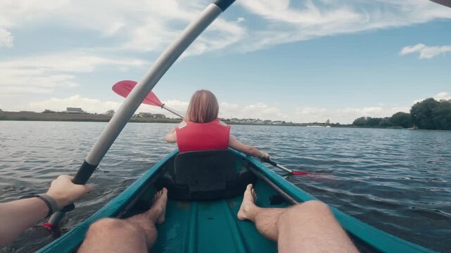 Father And Young Daughter Canoeing On A Lake Enjoy A Happy Family Weekend