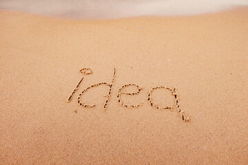 the inscription Idea on the seashore with palm trees
