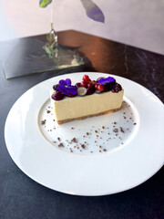Simple mascarpone cheesecake with winter berry forest fruits, serving slices