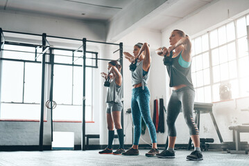 Fitness, women and exercise with kettlebell for weight training, wellness and body workout. Team, cardio and personal trainer challenge with active routine for health group at class in gym center