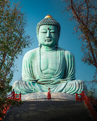 Woman Posing Before the Great Buddha of Kamakura-Style at Wat Doi Phra Chan, Lampang