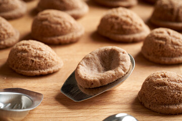 Freshly baked homemade Christmas cookies in the form of nuts in tin moulds