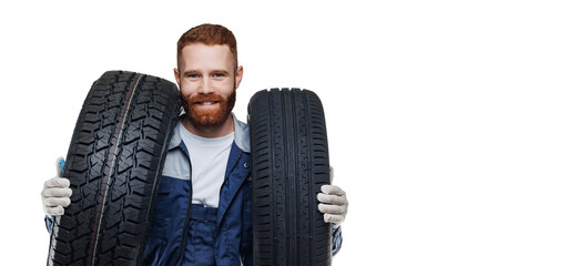 Auto mechanic hold two car tires on isolated white background with copy space © Parilov